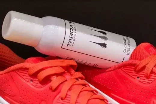 Pianka czyszcząca do sneakersów Tarrago - opakowanie leżące na czerwonych sneakersach